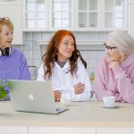 Trois femmes seniors se retrouvant dans la cuisine d'une maison